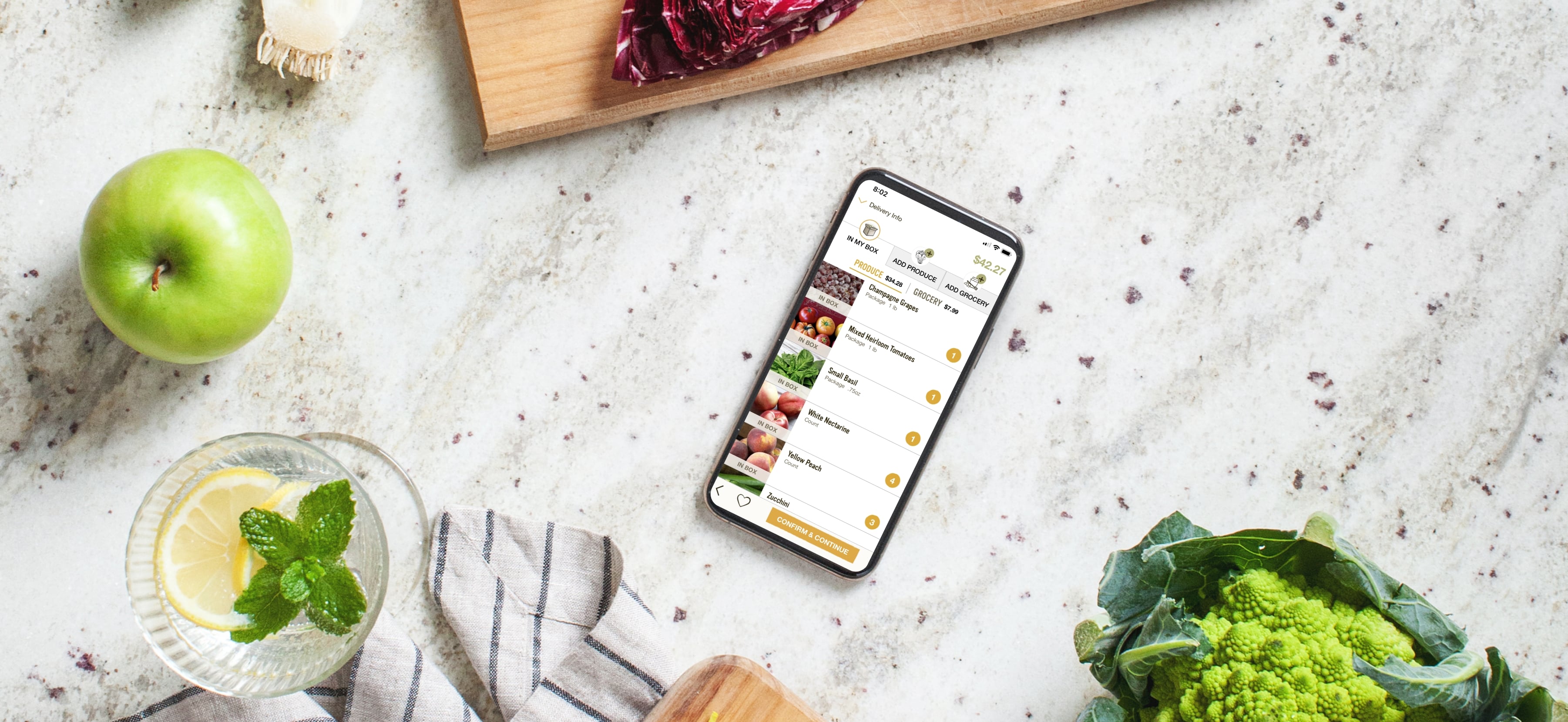 counter top with delicious farm fresh food and app showing on phone